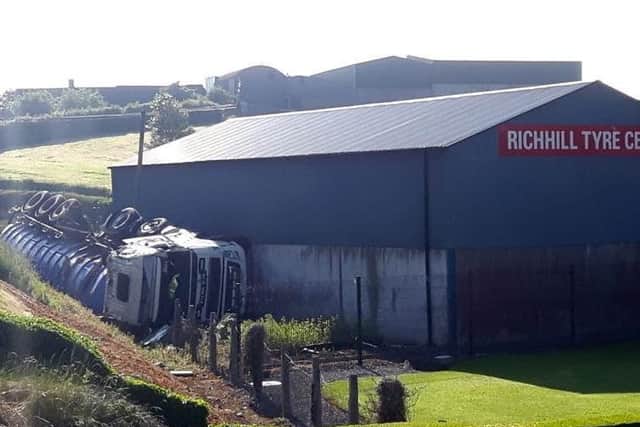 Large lorry carrying animal blood toppled down an embankment into Richhill Tyre Centre