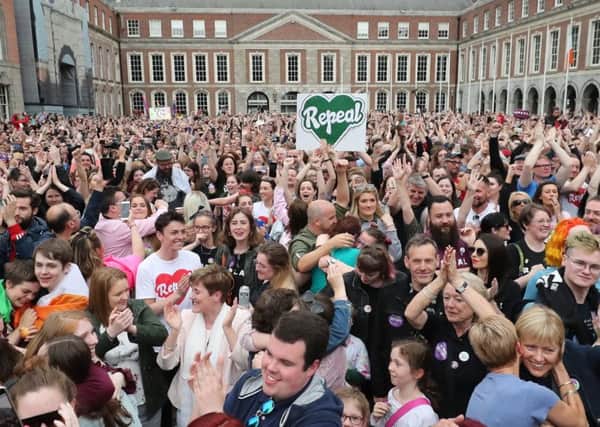 People celebrate in Dublin Castle on Saturday after voters opted to repeal the Eighth Amendment