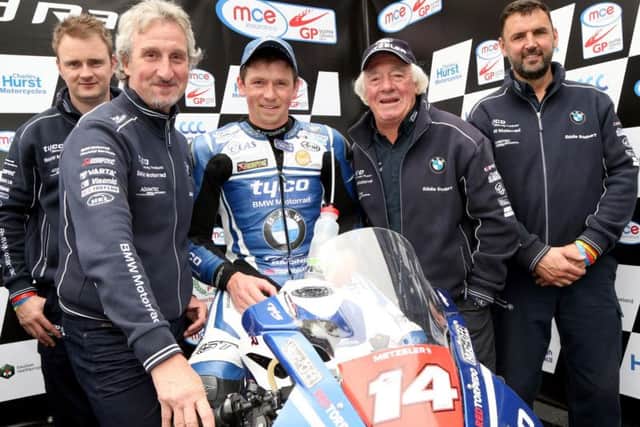 Dan Kneen with Tyco BMW team owners Philip (left) and Hector (second right) Neill at the Ulster Grand Prix last year.
