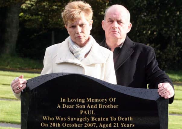 The parents of south Armagh murder victim Paul Quinn at his grave. They believe Provisional IRA members were responsible for the 2007 attack