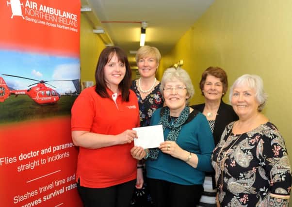 Yvonne Crabbe of Slemish Area WI presents a charity cheque to
Michelle McDaid of Air Ambulance.  Pictured are Isabel Halliday, Sophia
Maybin and Diane Murdoch.