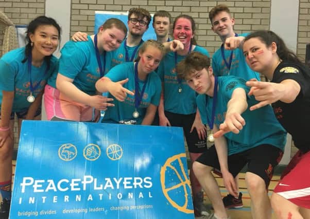 Coach Joanne Fitzpatrick, far right, with her team from the Peace Players International basketball league in Belfast.