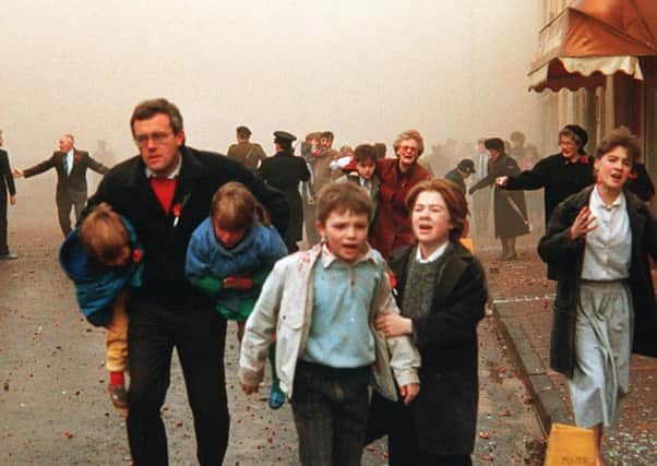 People flee in the aftermath of the IRAs Enniskillen Poppy Day massacre in 1987. one of the worst atrocities in the history of Northern Irelands Troubles