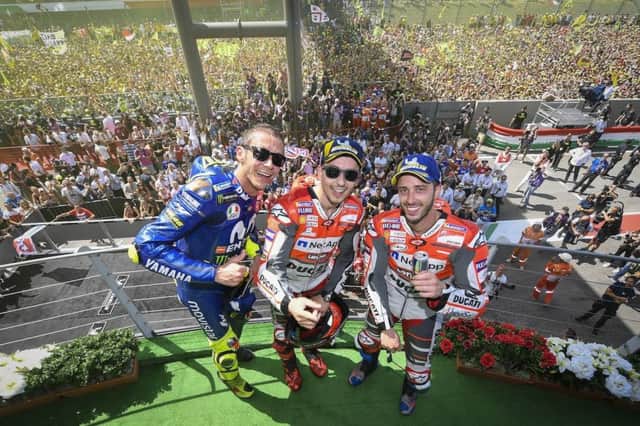 Jorge Lorenzo takes first win for  Ducati and celebrates alonside Valentino Rossi and Andrea Dovizioso.