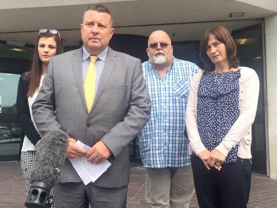 PC Matthew Deschoolmeester speaks to the press outside Swansea Crown Court, whilst (left to right) Rebecca Evans sister Elen Evans, father Brian Evans and mother Meryl Evans look on