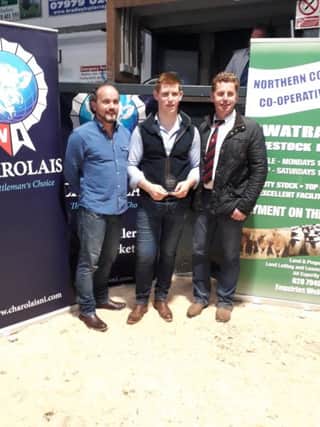 Mark Reid been preseted with his prize at the youth stock judging event at Swatragh with judge Gary Henderson and Garry Scott CIP Insurance Brokers Ltd sponsor of the event