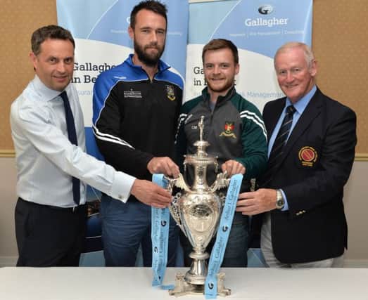 Nigel Jones of holders CIYMS (second left) and  Chris Martin of Downpatrick at the draw for the quarter finals of the Northern Cricket Union's Gallagher Senior Challenge Cup. The draw was made by  Shane Matthews, managing director of Gallagher Northern Ireland and Clarence Hiles, President of the NCU. PICTURE: Rowland White