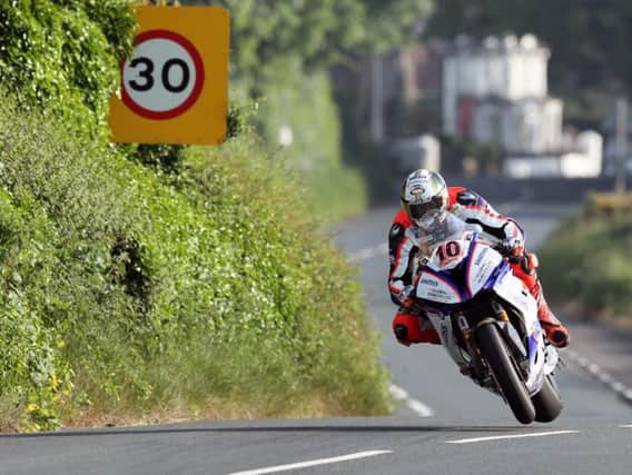 Peter Hickman won the Senior TT on the Smiths BMW as he set a new 135mph lap record on Friday.