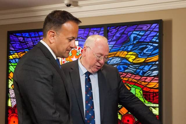 Rev Mervyn Gibson shows Taoiseach Leo Varadkar the memorial book, which carries details of Orange Order members murdered during the Troubles. Pic by Graham Curry