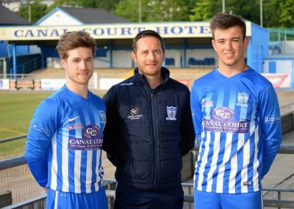Newry City AFC manager Darren Mullen (centre) with, from left, Stefan Lavery and TiarnÃ¡n Rushe. Pic by Brendan Monaghan Photography.