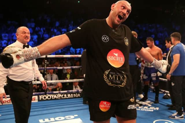 Tyson Fury (centre) celebrates victory over Sefer Seferi