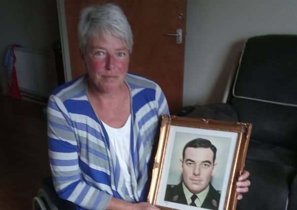 Andrea Brown with a photograph of her late father, RUC Sergeant Eric Brown, who was murdered by the IRA in January 1983