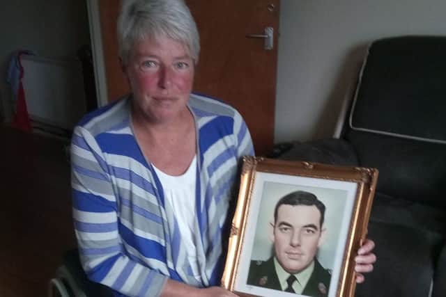 Andrea Brown with a photograph of her late father, RUC Sergeant Eric Brown, who was murdered by the IRA in January 1983