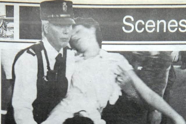 Andrea Brown, then aged 18, is helped into an ambulance moments after the blast
