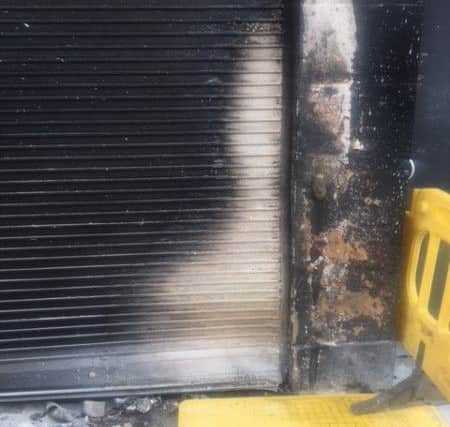 The front of Butler's Barber Shop was damaged after a wheelie bin was set on fire and pushed up against the front of the property.