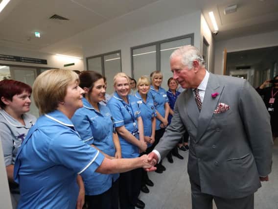 The Prince of Wales greets the nurses in the palliative care unit as he visits Omagh Hospital as part of his tour of Northern Ireland