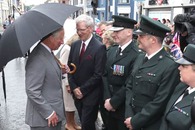 The Prince of Wales speaks to firemen who were first responders at the Omagh bombing