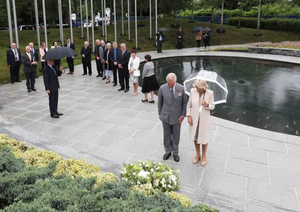 The Prince of Wales and the Duchess of Cornwall lay a wreath at the Omagh Bomb memorial garden as part of their tour of Northern Ireland