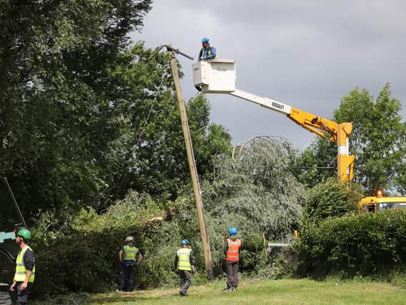 Electricity workers fixing damage after storm Hector
