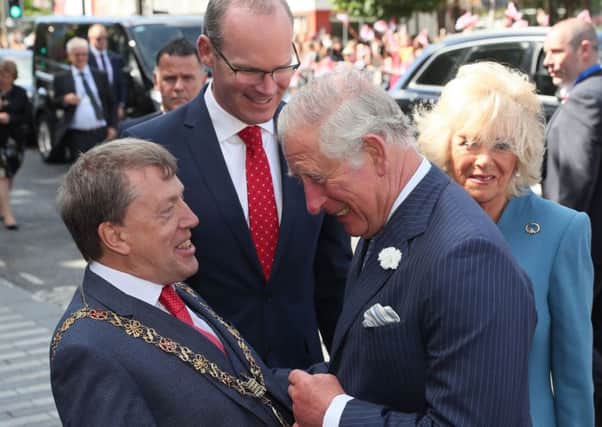 The Prince of Wales (centre) and the Duchess of Cornwall (right) meet Minister for Foreign Affairs Simon Coveney (back) and Lord Mayor of Cork Tony Fitzgerald (left) during a visit to the English Market in Cork as part of their tour of the Republic of Ireland. PRESS ASSOCIATION Photo. Picture date: Thursday June 14, 2018. See PA story ROYAL Charles. Photo credit should read: Brian Lawless/PA Wire