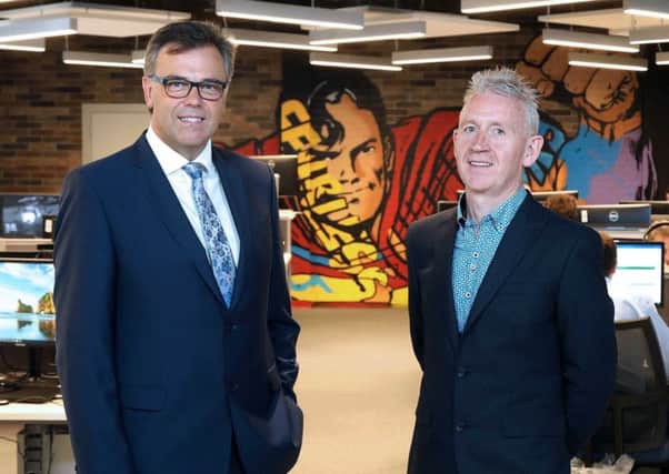 Novosco MD Patrick McAliskey, right, pictured at the firms Belfast HQ with Invest NI CEO Alastair Hamilton