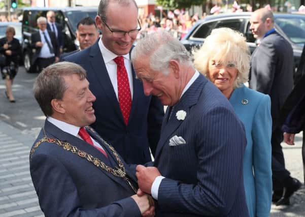 The Prince of Wales (centre) and the Duchess of Cornwall (right) meet Minister for Foreign Affairs Simon Coveney (back) and Lord Mayor of Cork Tony Fitzgerald (left) during a visit to the English Market in Cork