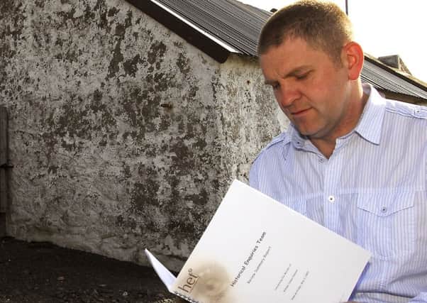 Samuel Heenan, from Drumlough Cross, Rathfriland, reads the Historical Enquries Team Review Summary report into the 1985 IRA murder of his father, William, close to the spot were he discovered his father's body. The report was "pretty poor" writes William Matchett