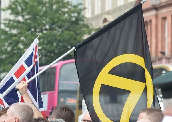 Generation Identity flags flown at a rally at Belfast City Hall in support of Tommy Robinson, the founder of the far-right English Defence League.