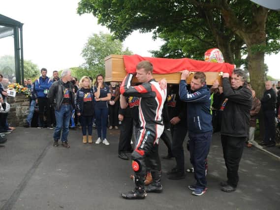 Dan Kneen's coffin was carried by his brother Ryan, who completed a tribute lap in his memory around the TT course two days after the fatal crash.
