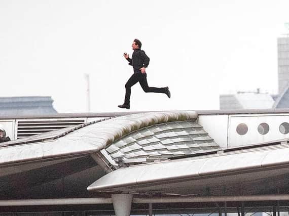 Tom Cruise running along Blackfriars Bridge in London, during filming for Mission Impossible 6.