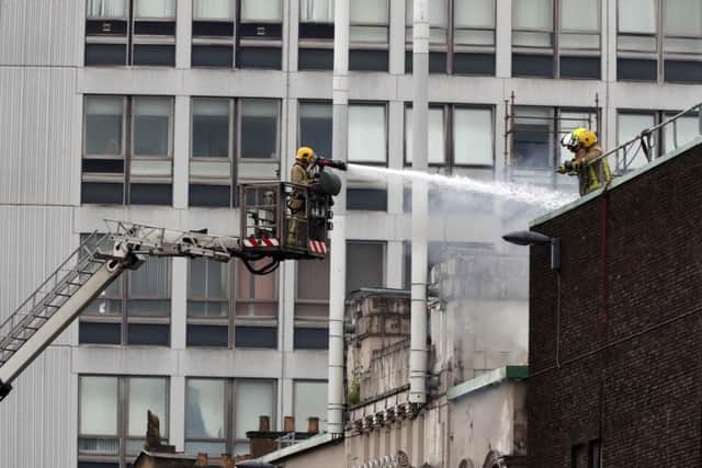 Firefighters douse the O2 ABC close to the historic Mackintosh Building in Glasgow following the blaze at the Glasgow School of Art (GSA) building.