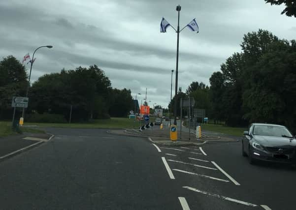 Israeli flags erected at the entrance to Craigavon Hospital are designed to intimidate, say Sinn Fein's John O'Dowd