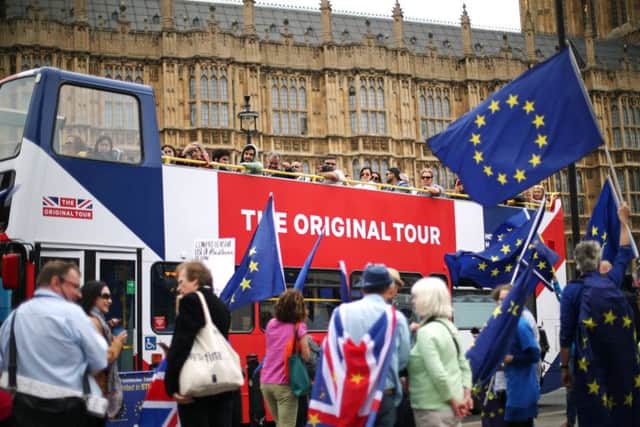 Anti-Brexit demonstrators campaign outside the Houses of Parliament in London. Photo credit: Yui Mok/PA Wire