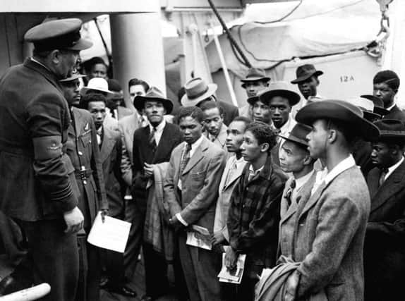 EMBARGOED TO 0001 FRIDAY JUNE 22  File photo 22/06/48 of Jamaican immigrants welcomed by RAF officials from the Colonial Office after the ex-troopship HMT 'Empire Windrush' landed them at Tilbury. Friday marks the 70th anniversary of the generationÃ•s beginning when about 500 Caribbeans stepped off the Empire Windrush in Tilbury Docks, Essex, to join the effort to rebuild post-war Britain. PRESS ASSOCIATION Photo. Issue date: Friday June 22, 2018. See PA story ANNIVERSARY Windrush. Photo credit should read: PA/PA Wire