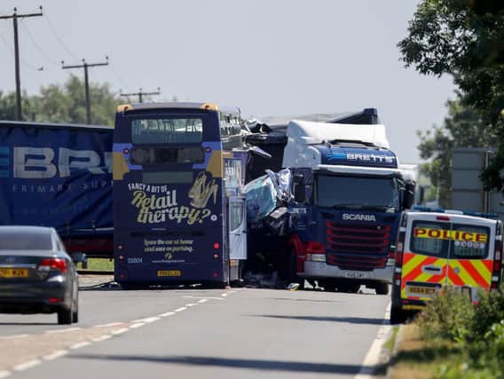 A bus and an articulated lorry on the A47 at Thorney Toll near Wisbech in Cambridgeshire following a collision earlier this morning which injured sixteen people
