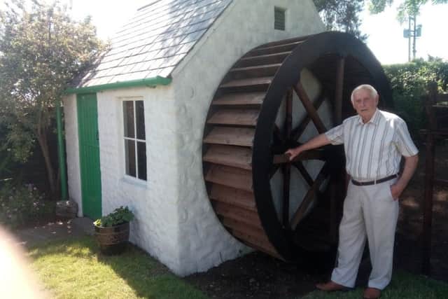 Brian with his waterwheel and mill which he contructed himself
