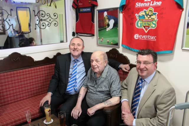 Carrickfergus Manor resident, Bobby (centre), with Jonathan Lamont and Drew McCoubrey, directors of Linfield FC.