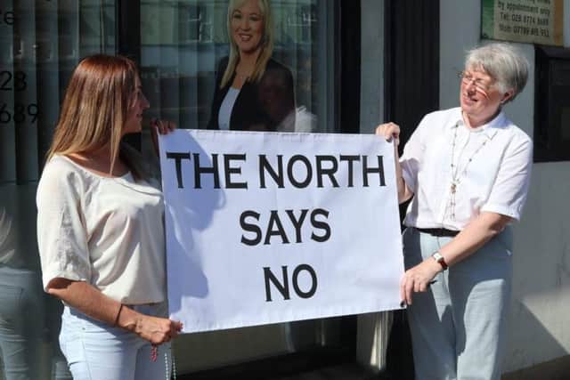 Doris Vincent and Catherine Sewell make their point outside Michelle O'Neill's office in Coalisland.