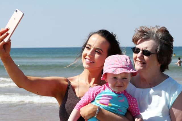 Francesca McKillion, Sophia McKillion and Marion McKillion from Dungannon capture memories of their day out on the beach at Portstewart