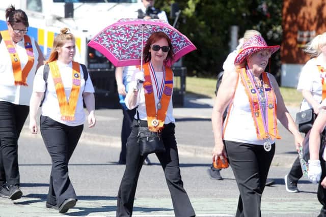 Taking shelter from the sun during the annual Whiterock Orange Order parade in Belfast