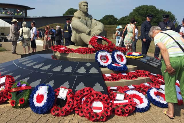 People after a ceremony to honour the 25th anniversary of the unveiling of the Battle of Britain memorial in Capel-le-Ferne, Kent