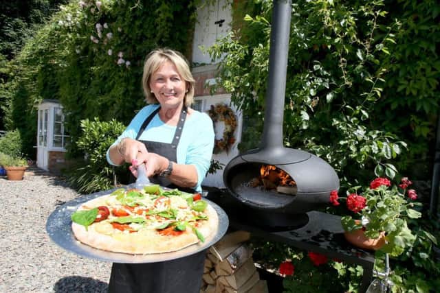 Jenny Bristow cooking a pizza at her wood burning stove