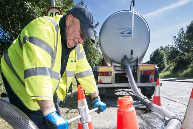 An NI Water employee engaged in tanker refill. This operation is to support the replenishment of supply at one of a number of NI Water reservoirs.
