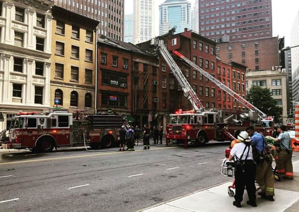 Firefighters at The Dead Rabbit in Lower Manhattan after the fire was discovered on Sunday morning
