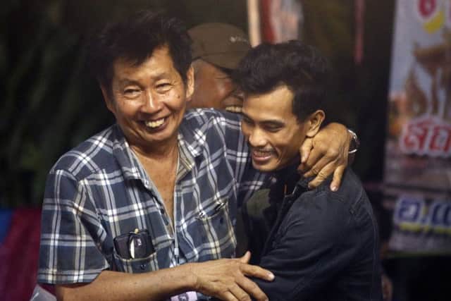 Family members smile after hearing the news that the missing 12 boys and their soccer coach have been found in Mae Sai, Chiang Rai province, in northern Thailand, Monday, July 2