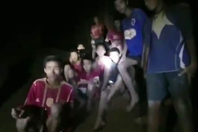In this grab taken from video provided by the Thai Navy Seal, a view of the boys and their soccer coach as they are found in a cave, in Chiang Rai in Thailand, Monday, July 2, 2018.  However getting them out of the caves will require more time and thought. (Thai Navy Seal via AP)