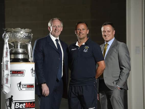 Dungannon Swifts manager Rodney McAree pictured with competition sponsor Paul McLean from BetMcLean and NI Football League Manging Director Andrew Johnston.