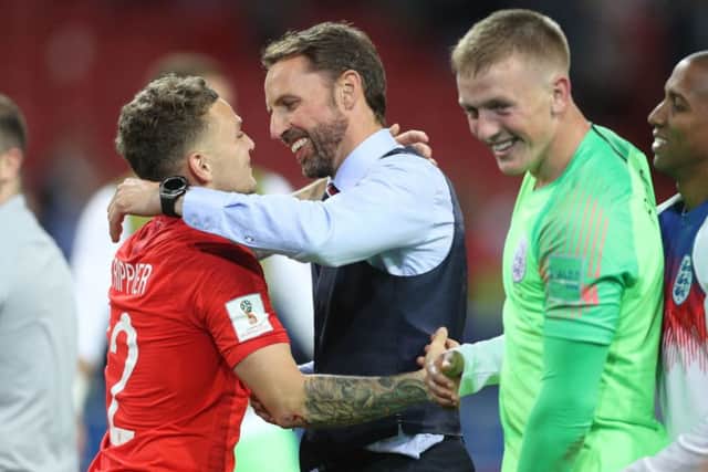 England manager Gareth Southgate celebrates the penalty shoot-out defeat of Colombia with Kieran Trippier (left) and Jordan Pickford