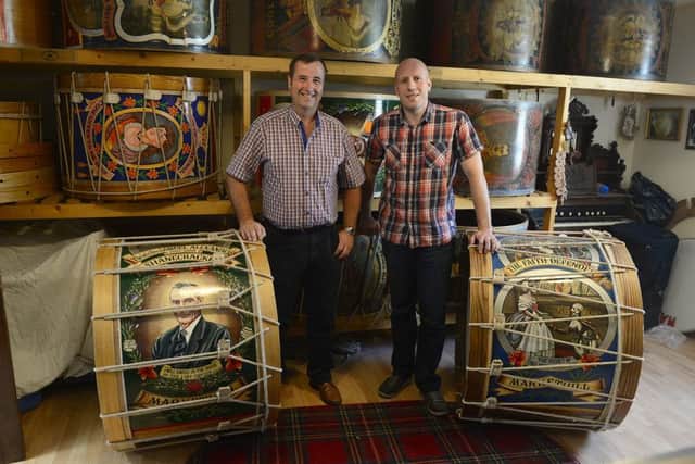 Lambeg manufacturer David Alexander from Markethill with News Letter journalist Graeme Cousins, who is pictured inset trying (without much success) to master the art of playing the Lambeg drum. Picture by Arthur Allison / Pacemaker Press