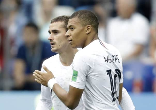 France's Antoine Griezmann is congratulated by teammate Kylian Mbappe
